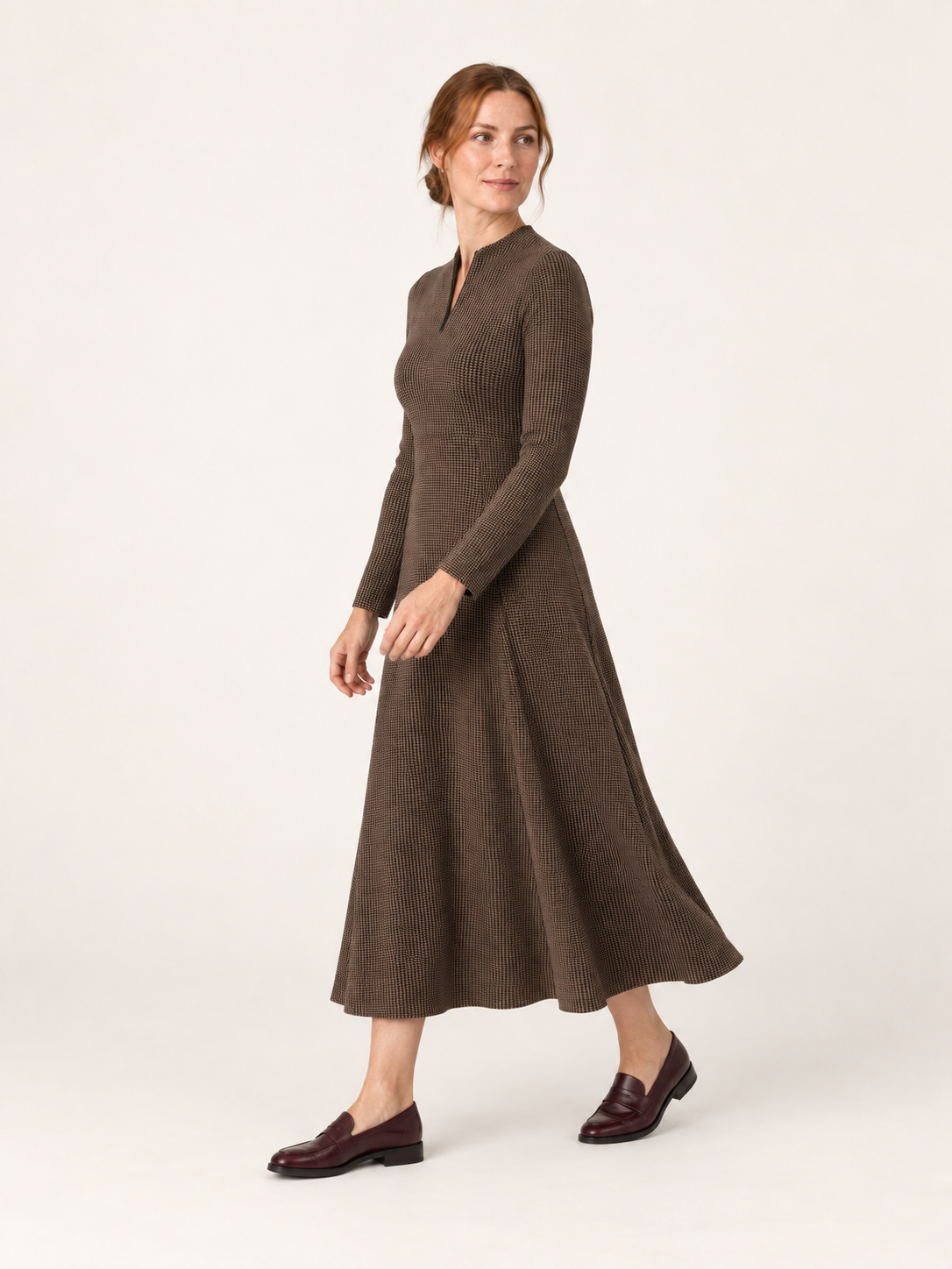 Brown houndstooth zip-neck midi dress, side-movement view