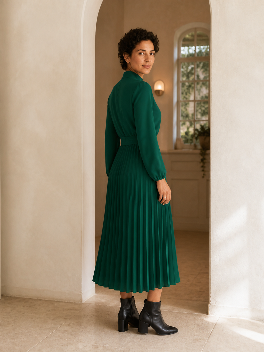 Green pleated midi dress styled with black ankle boots
