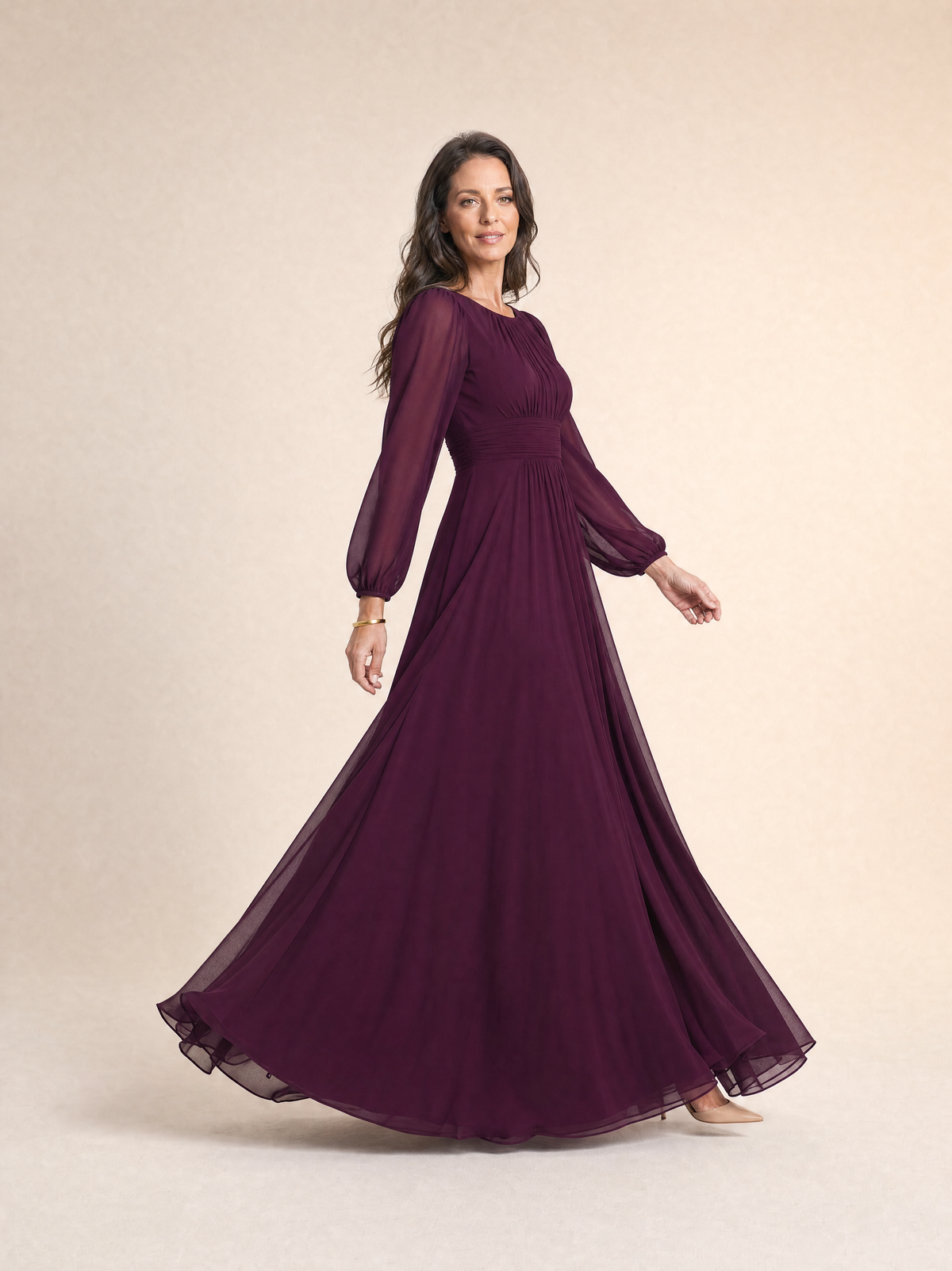 The mulberry chiffon dress in movement, the pleated skirt opening as she walks