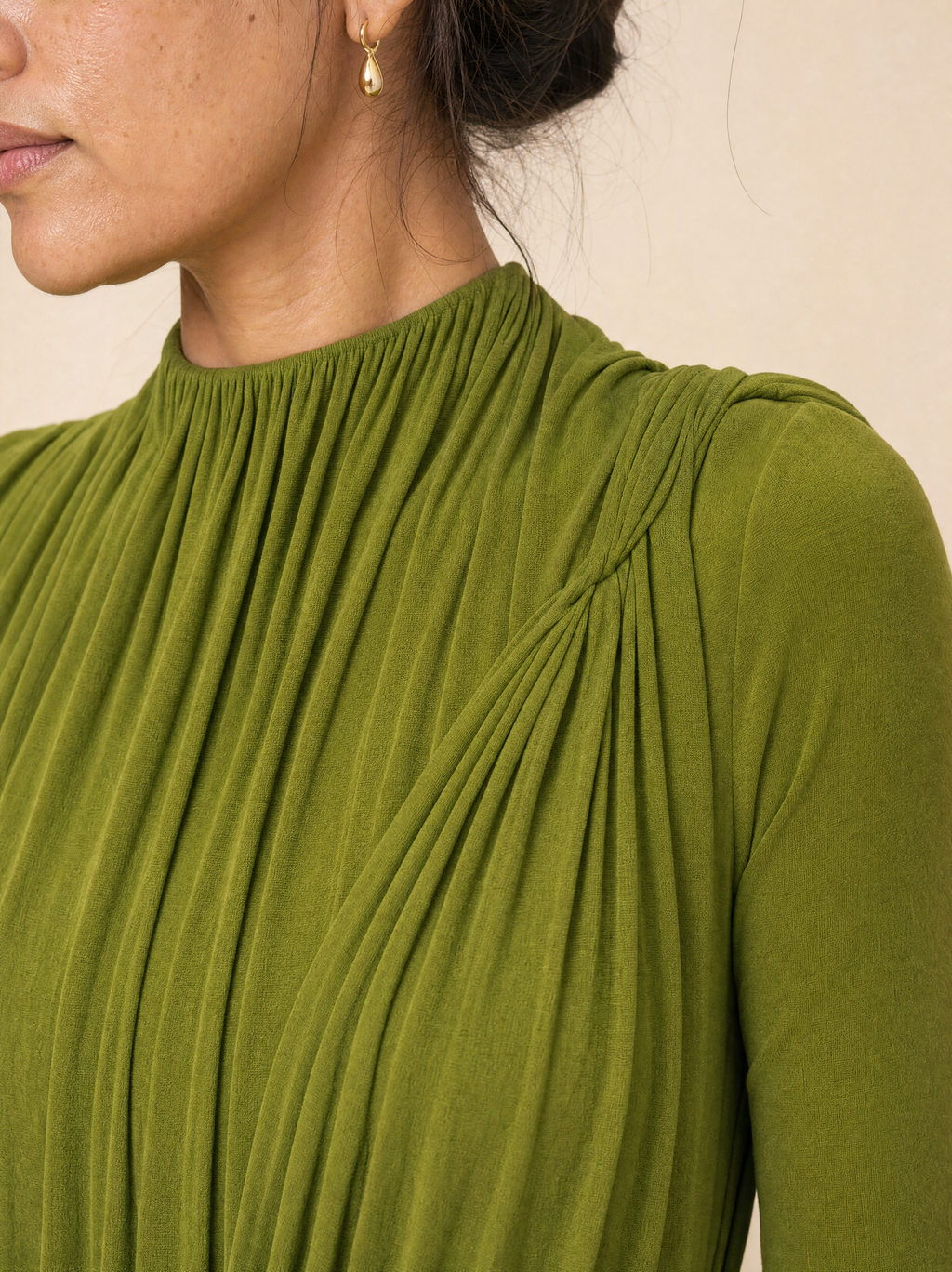 Close up of the ruched high neck and the gathered drape at the shoulder
